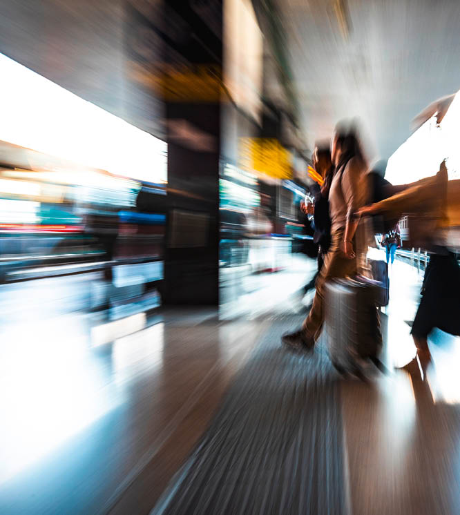 people in the station as they walk fast, blurred photo