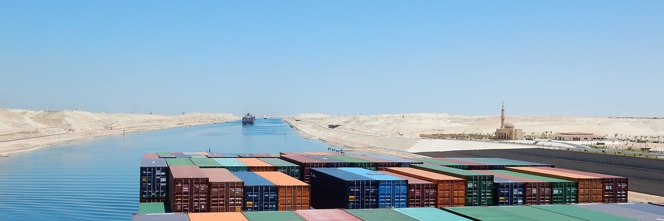 A container ship with many containers sails towards waters in the Middle East
