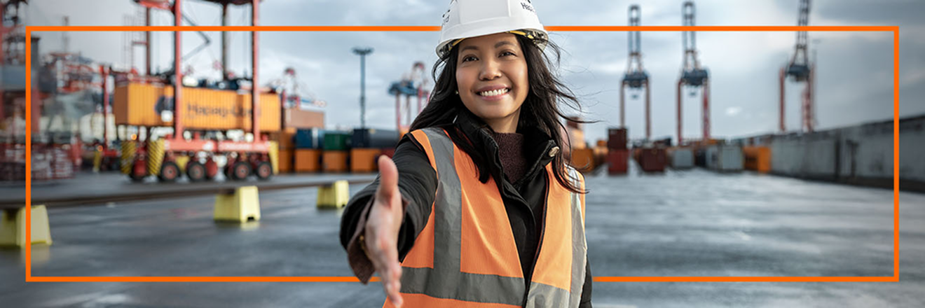 Woman in a high-viz vest holding out her hand ready for a handshake