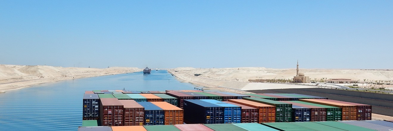 A container ship with many containers sails towards waters in the Middle East